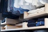 Kleiderschrank mit nach Farbe sortierter Kleidung