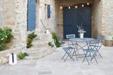 Innenhof griechisch inspiriert mit blauen Gartenmöbeln