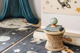 Kinderzimmer mit bunten Teppichen und blauem Baldachin