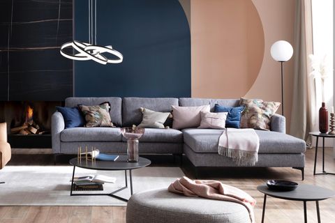 Graues Sofa mit Kissen in Rosa- und Blautönen