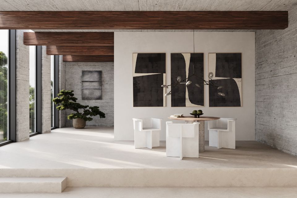 Weiße, blockartige beton-Stühle vor Wandkunst in großzügigem Raum mit Decken und Wänden aus Beton