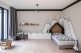 Kinderzimmer mit Bett, Schreibtisch und weißen Bergen an der Wand