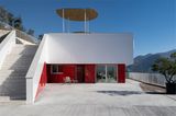 Architektenhaus in rot-weiß mit großer Terrasse vor mediterraner Landschaft